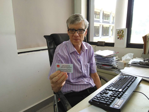 Richard Corlett receives Foreign Permanent Resident ID Card